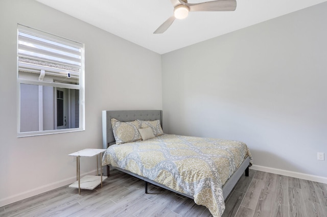 bedroom with light hardwood / wood-style floors and ceiling fan