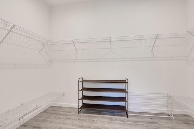 spacious closet featuring hardwood / wood-style floors