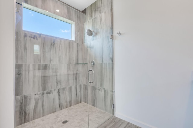 bathroom featuring wood-type flooring and an enclosed shower