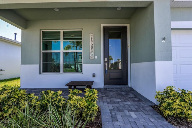 view of exterior entry with covered porch