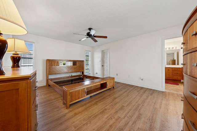 bedroom with light wood-type flooring, connected bathroom, and ceiling fan