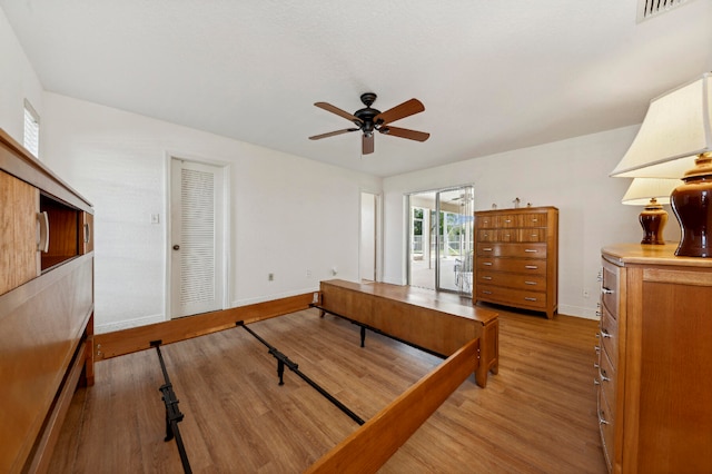 bedroom featuring access to outside, a closet, and light hardwood / wood-style floors