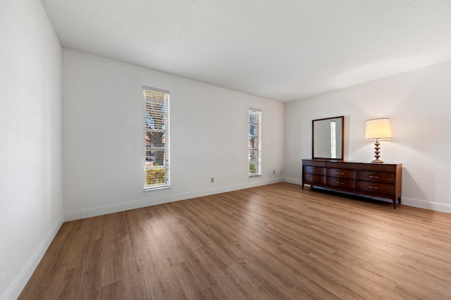 empty room with hardwood / wood-style flooring