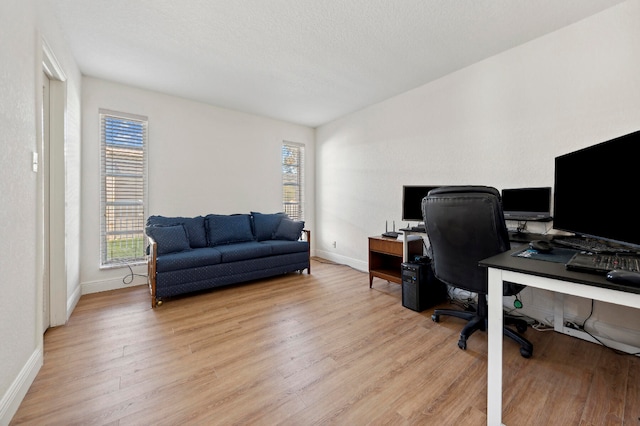 office featuring a textured ceiling and light hardwood / wood-style flooring