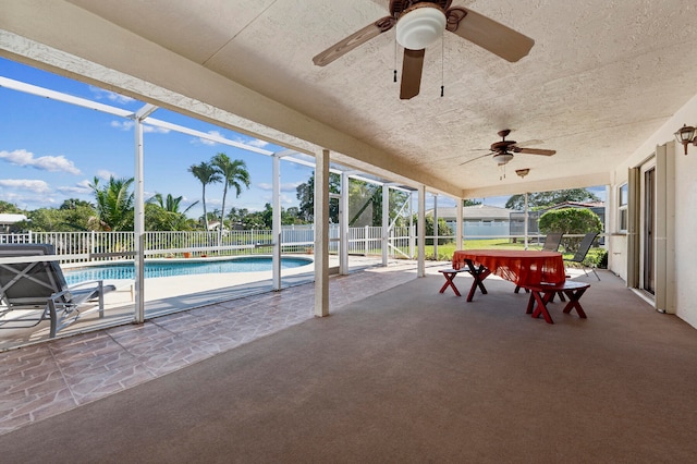 view of patio featuring a fenced in pool, ceiling fan, and a lanai