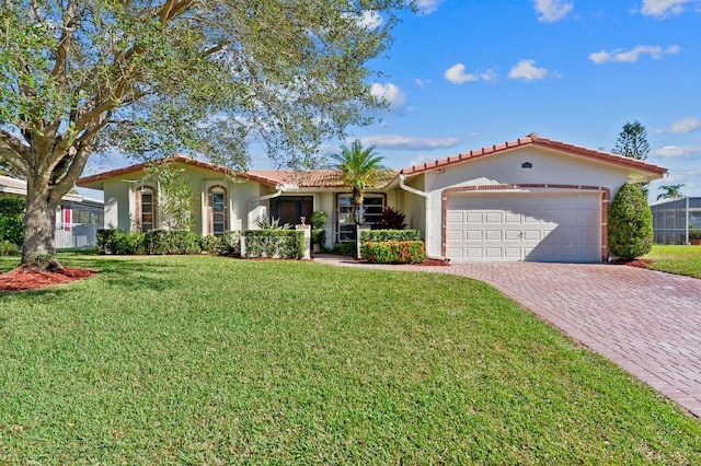 mediterranean / spanish-style home with a garage and a front lawn