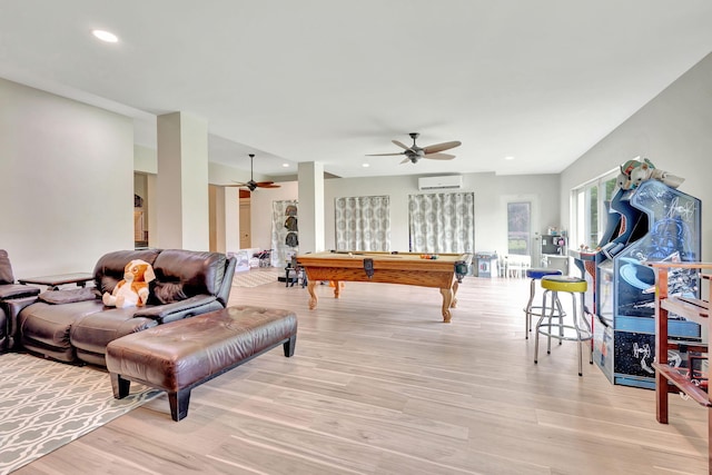 game room featuring a wall mounted air conditioner, ceiling fan, light wood-type flooring, and pool table