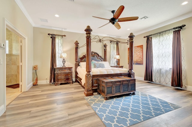 bedroom featuring ensuite bathroom, ornamental molding, a textured ceiling, ceiling fan, and light hardwood / wood-style flooring