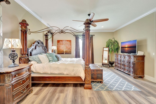 bedroom featuring ceiling fan, light hardwood / wood-style flooring, and crown molding