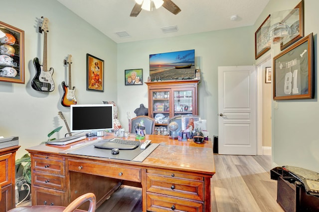 home office with ceiling fan and light hardwood / wood-style floors