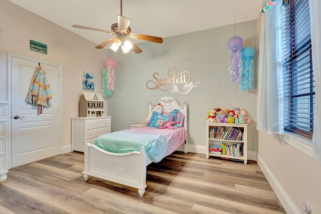 bedroom with light hardwood / wood-style floors and ceiling fan