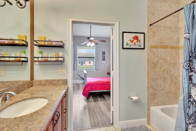 bathroom with hardwood / wood-style flooring, vanity, shower / bath combination with curtain, and ceiling fan