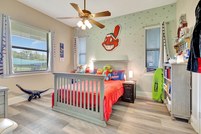 bedroom with ceiling fan and light wood-type flooring