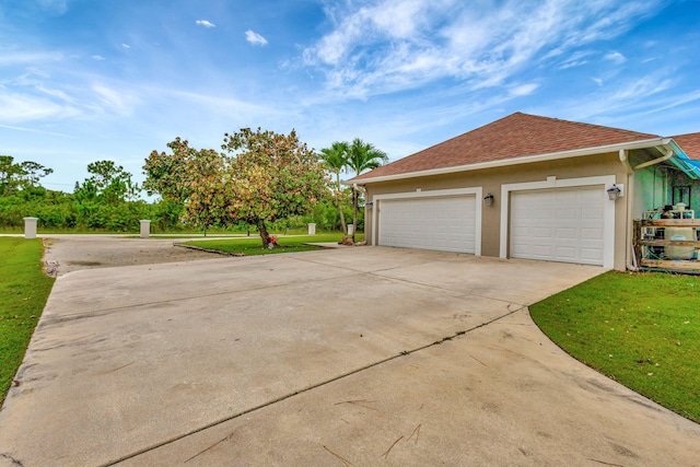 view of property exterior featuring a garage and a lawn