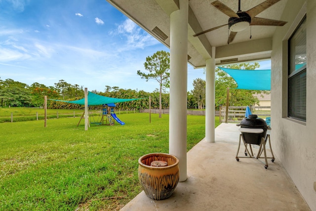 view of yard featuring ceiling fan and a playground