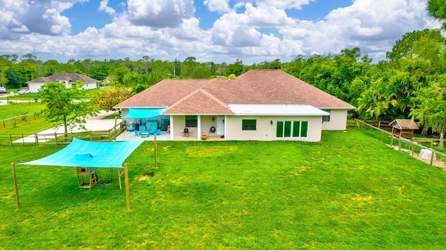 back of house featuring a patio and a yard