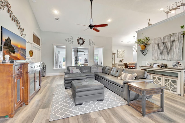 living room featuring light hardwood / wood-style flooring and ceiling fan