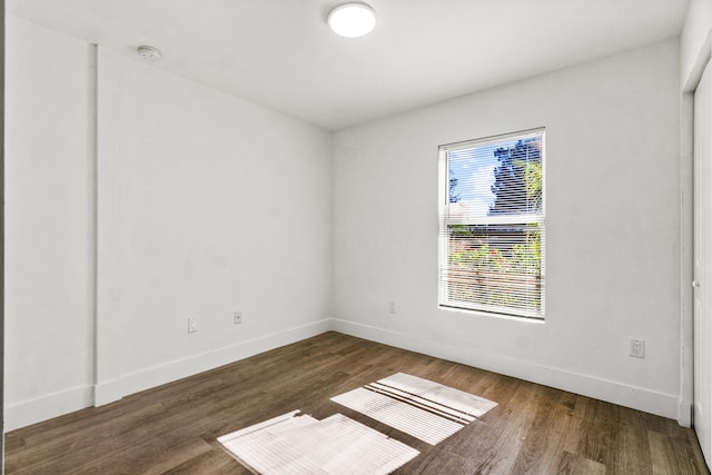 spare room with dark hardwood / wood-style flooring