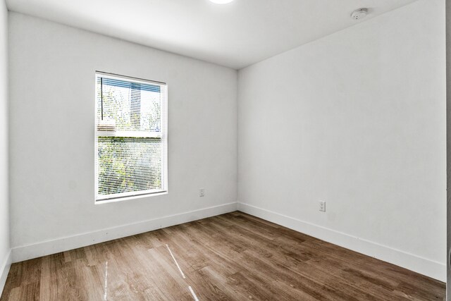 spare room with wood-type flooring