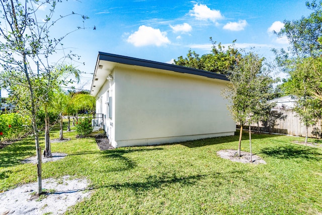 view of property exterior with a yard