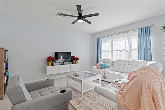 living room featuring ceiling fan and light hardwood / wood-style flooring