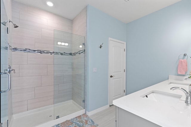 bathroom with vanity and a shower with shower door