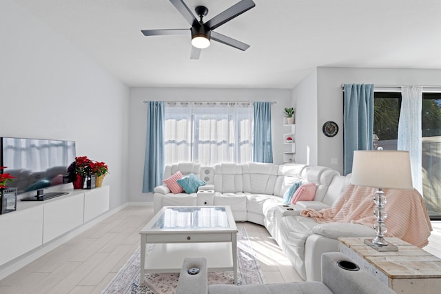 living room with ceiling fan and light hardwood / wood-style floors