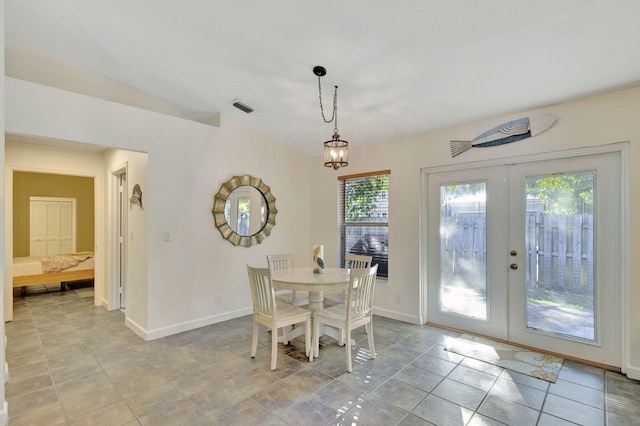 dining room featuring an inviting chandelier, light tile patterned floors, and french doors