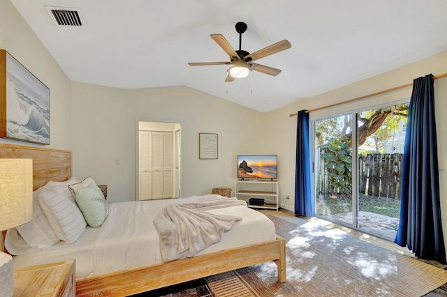 bedroom with ceiling fan, vaulted ceiling, access to exterior, and a closet