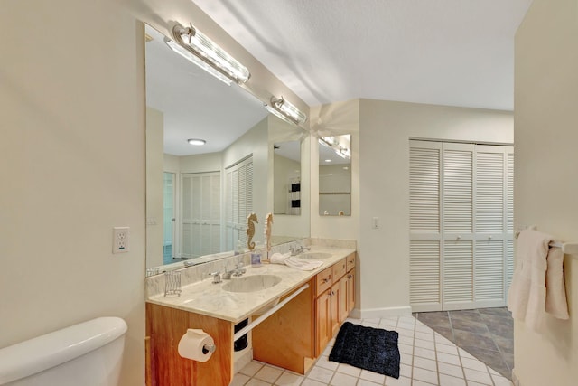 bathroom with tile patterned flooring, vanity, and toilet