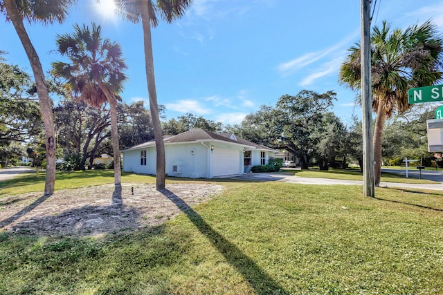 view of side of home with a lawn and a garage