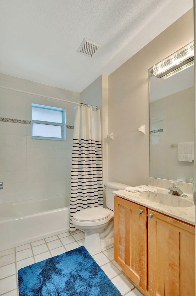 full bathroom with tile patterned flooring, a textured ceiling, toilet, shower / bath combo with shower curtain, and vanity