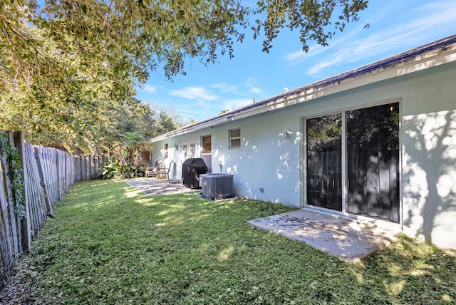 view of yard with a patio and central AC unit