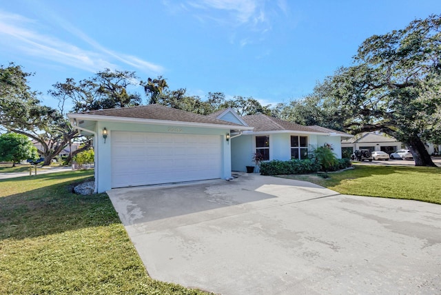 ranch-style home featuring a garage and a front lawn