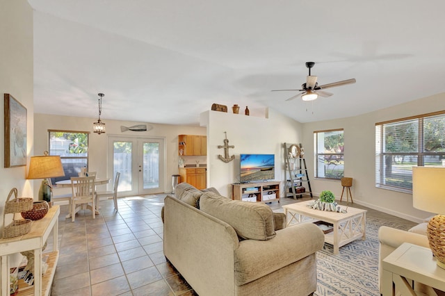 tiled living room featuring plenty of natural light, ceiling fan, lofted ceiling, and french doors