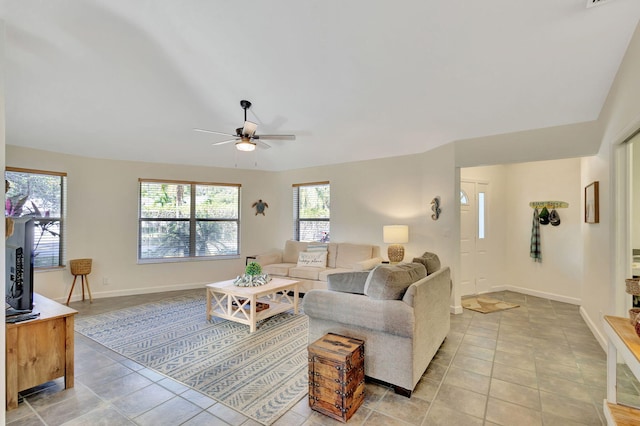 living room with ceiling fan and light tile patterned floors