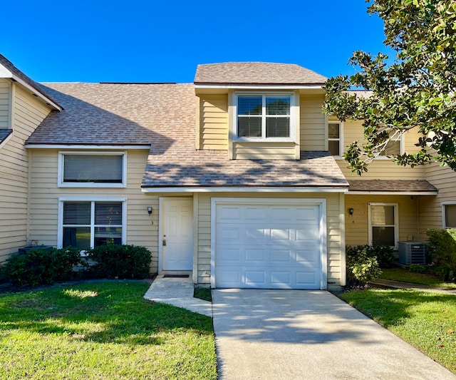 view of front facade with central AC, a front lawn, and a garage