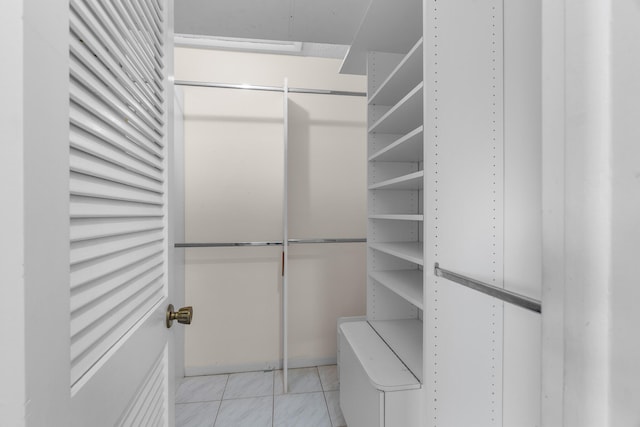 walk in closet featuring light tile patterned flooring