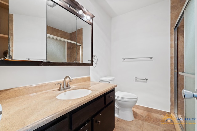 bathroom with an enclosed shower, vanity, and toilet