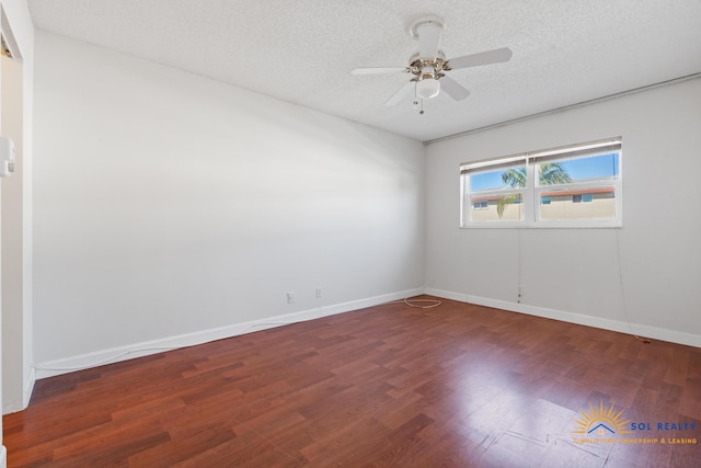 spare room with a textured ceiling, ceiling fan, and dark hardwood / wood-style floors