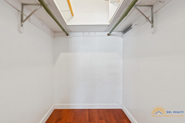 walk in closet with wood-type flooring