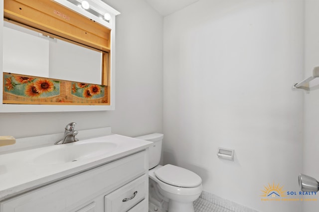 bathroom featuring tile patterned flooring, vanity, and toilet