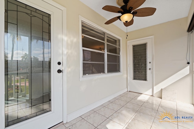 property entrance with ceiling fan