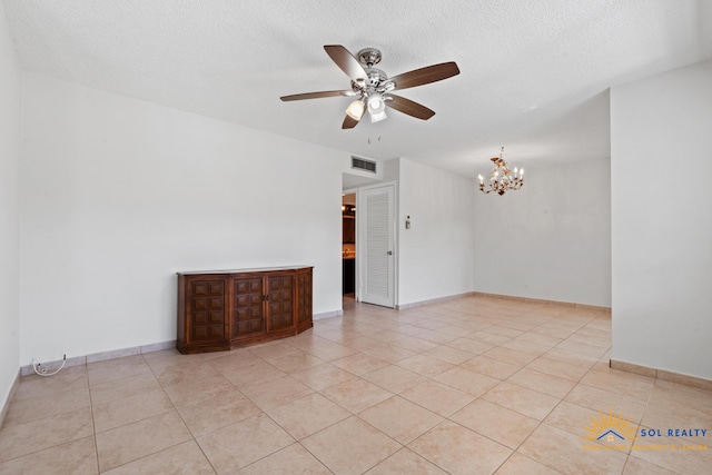 unfurnished room with light tile patterned floors and ceiling fan with notable chandelier