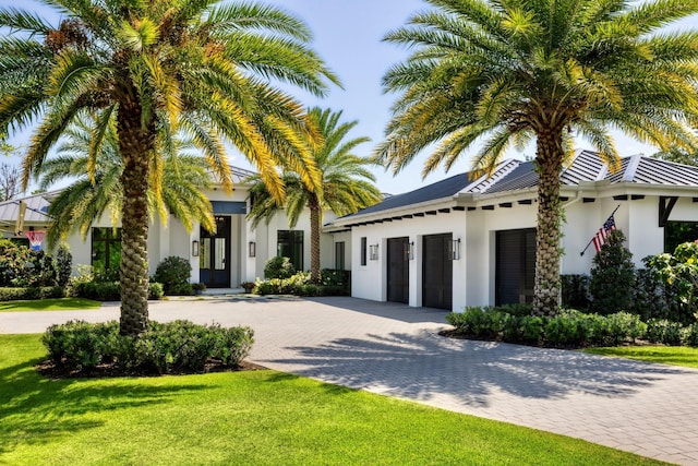 mediterranean / spanish home featuring a front lawn