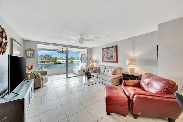 living room with ceiling fan and light tile patterned floors