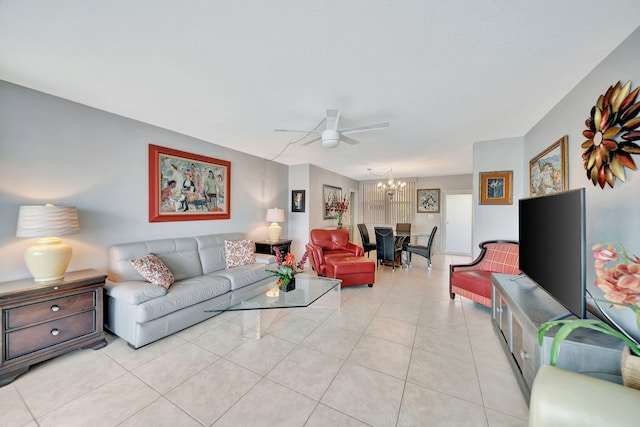 living room with light tile patterned floors and ceiling fan with notable chandelier