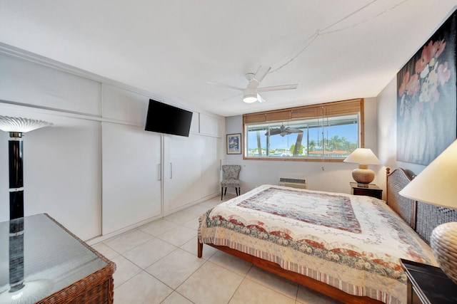 bedroom with ceiling fan and light tile patterned flooring