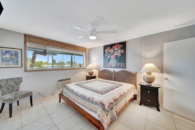 tiled bedroom with a wall unit AC and ceiling fan