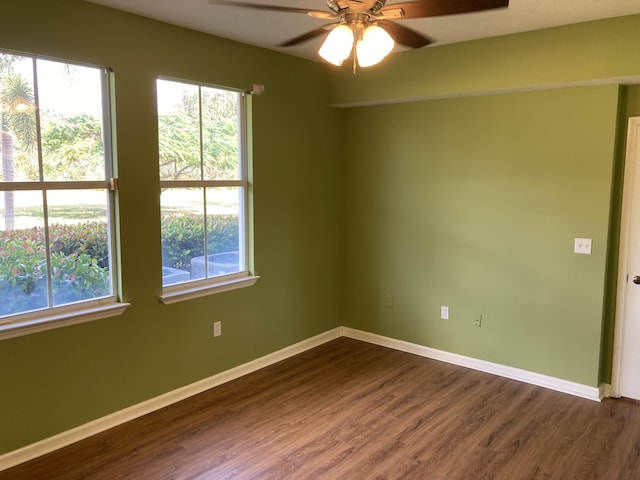 spare room featuring dark hardwood / wood-style flooring and ceiling fan